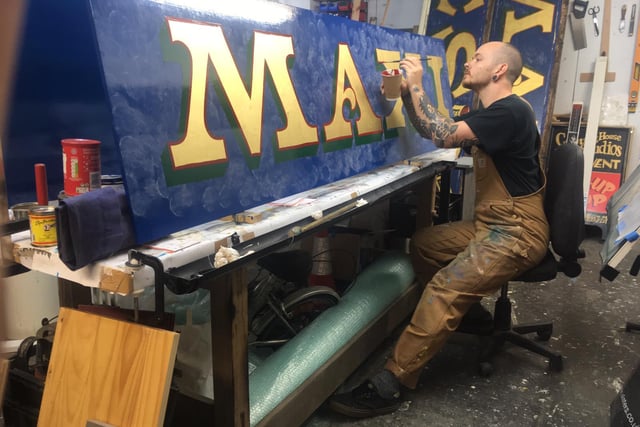 The 34-year-old at work painting the Maxies sign for the bistro in Johnston Terrace, Edinburgh. The original sign was painted by the late Robin Abbey who was a huge inspiration for Tatch when he started out signwriting in the Capital. As a tribute to the legend signwriter, Tatch decided to paint an exact replica of Robin's work when it was due to be refurbished.