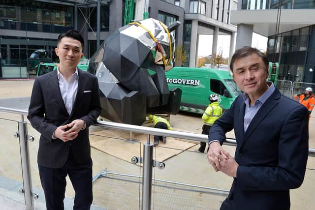 Rongmin Qin, executive director, and Jerry Cheung, managing director of New Era development UK, with the panda sculpture.
