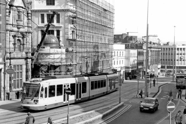A Supertram on High Street, Sheffield, outside Kemsley House, which is undergoing building work, in April 1994, with C&A in the distance.