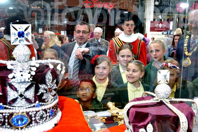 The replica Crown Jewels on display in the Bridges and pupils from Hudson Road Primary School are pictured admiring them.
