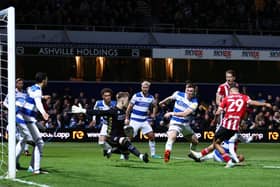 Iliman Ndiaye of Sheffield United (R) scores their team's first goal past Jimmy Dunne and Murphy Mahoney of Queens Park Rangers during the Sky Bet Championship match in west London: Ryan Pierse/Getty Images