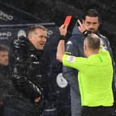 Referee Jonathan Moss (R) shows a red card to Aston Villa's head coach Dean Smith (L) during the Premier League football match between Manchester City and Aston Villa at the Etihad Stadium in Manchester (Photo by SHAUN BOTTERILL/POOL/AFP via Getty Images)