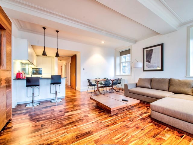 The £15k a month flat boasts a spacious, open-plan interior, with a large combined living room, dining area and kitchen space.