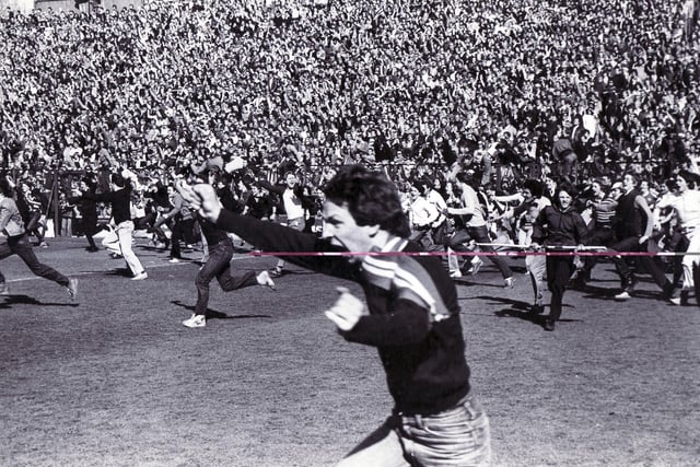 Fans race onto the pitch to celebrate promotion to Division Two in May 1980.