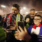 BARNSLEY, ENGLAND - MAY 19: Michael Duff, Manager of Barnsley, poses for a photo with fans on the pitch following the Sky Bet League One Play-Off Semi-Final Second Leg match between Barnsley and Bolton Wanderers at Oakwell Stadium on May 19, 2023 in Barnsley, England. (Photo by George Wood/Getty Images)