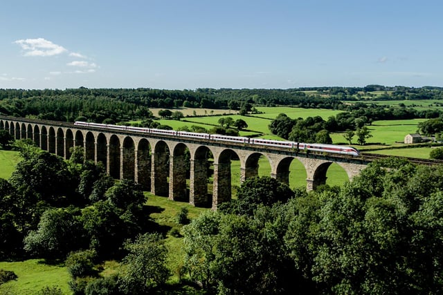 An LNER train on the iconic Crimple Valley viaduct just south of Harrogate, North Yorkshire.