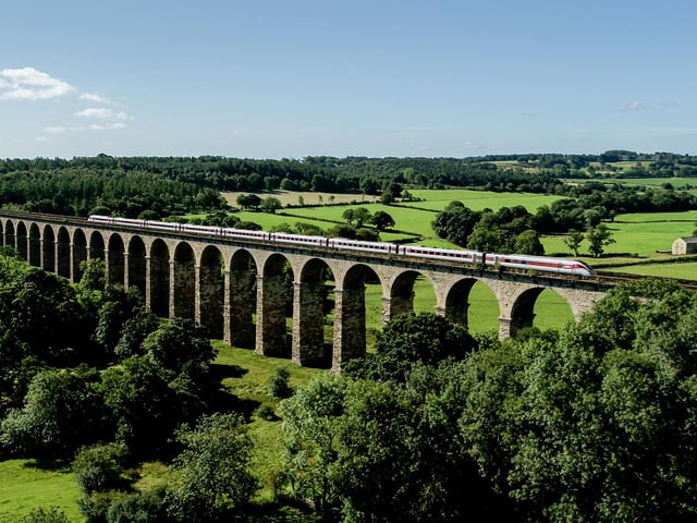 An LNER train on the iconic Crimple Valley viaduct just south of Harrogate, North Yorkshire.
