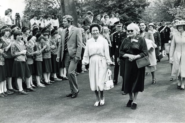 HRH Princess Margaret is escorted up the drive of Glenbrook, Bamford, the Guide Outdoor Activity Centre, by Lady Renwick (right), Chairman Glenbrook House Committee to the waving of flags and cheering of Guides and Ranger Guides on June 4, 1980