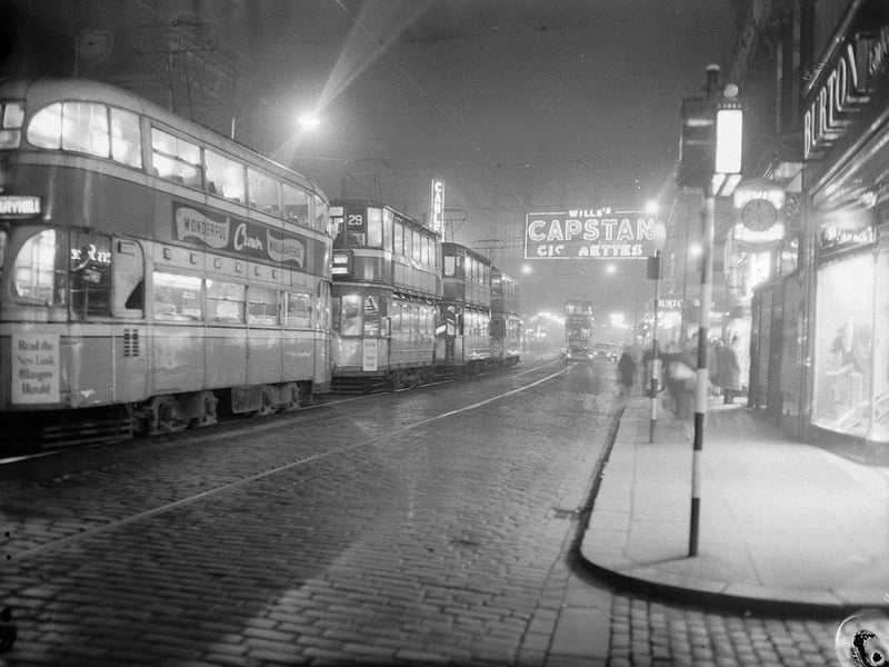 Trams in Argyle Street with neon signs, 1960s.