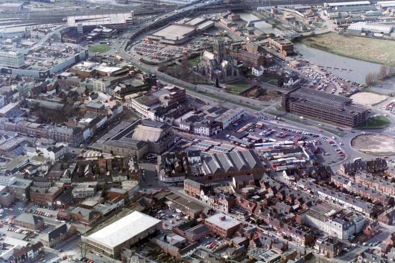 This view of the town centre shows the old market stalls and a very different waterfront with the old car park