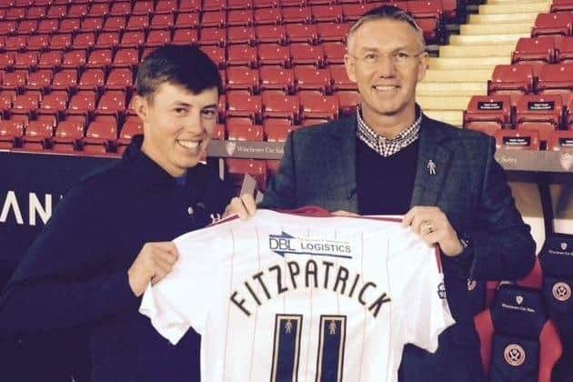 Matt Fitzpatrick is presented with a shirt bearing his name by Sheffield United's then-manager Nigel Adkins.