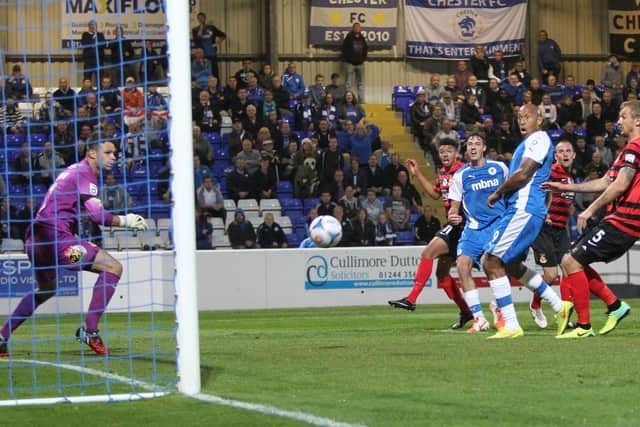 Heneghan fires home the shot that earned Chester a famous win over old foes Wrexham.