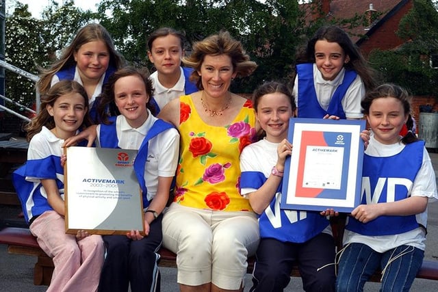 Pupils at Abbey Lane School celebrate the "Activemark" award from Sport England with PE co-ordinator Jackie Cottam, May 2003