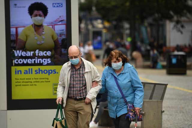 Shoppers in Sheffield wearing face masks (Photo by OLI SCARFF/AFP via Getty Images).