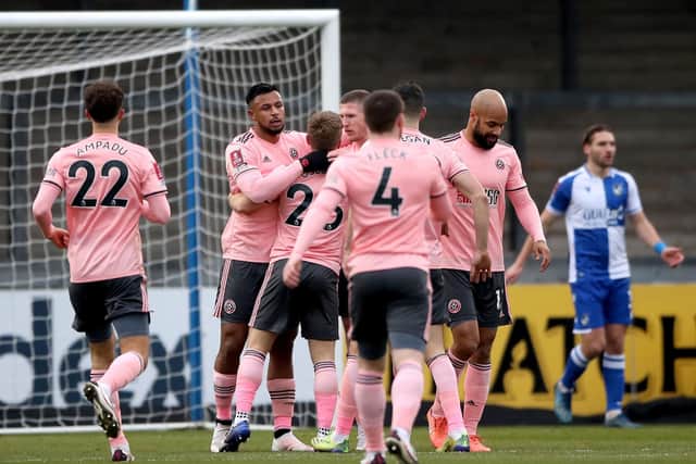 Sheffield United's Lys Mousset (second left) celebrates with his team-mates after Bristol Rovers goalkeeper Joe Day (not pictured) scores their side's first goal of the game with an own goal during the Emirates FA Cup third round match at Memorial Stadium: Nick Potts/PA Wire.