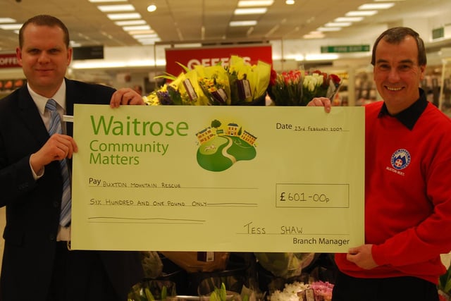 In 2009  Buxton Waitrose Store Duty Manager Dan Hopkinson, presented Roger Bennett, Treasurer of Buxton Mountain Rescue Team, with a cheque for £601 which was raised through the community matters scheme by shoppers