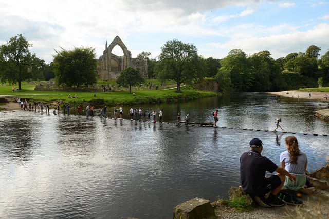 Not for nothing is Yorkshire often referred to as God's Own Country - the Dales are especially stunning, and the area has just been named the best national park in Europe by Tripadvisor's Travellers Choice Awards. Ingleton, Malham, Grassington and Settle are some of the best-known places to stay - here people are pictured using stepping stones to cross the River Wharfe at Bolton Abbey near Skipton.