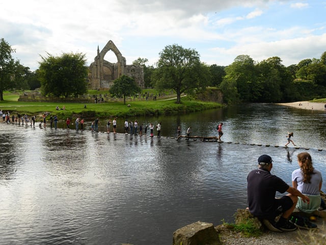 Not for nothing is Yorkshire often referred to as God's Own Country - the Dales are especially stunning, and the area has just been named the best national park in Europe by Tripadvisor's Travellers Choice Awards. Ingleton, Malham, Grassington and Settle are some of the best-known places to stay - here people are pictured using stepping stones to cross the River Wharfe at Bolton Abbey near Skipton.