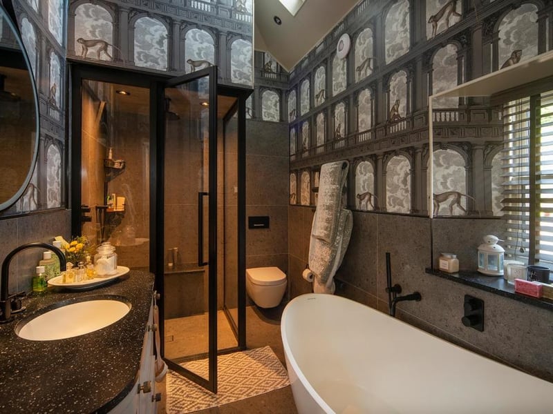 The bathroom has tiles from Villeroy & Boch, brassware from Dornbracht with a Burbidge vanity unit and an Ashton & Bentley freestanding bath, as well as a bespoke steam shower enclosure and underfloor heating.
