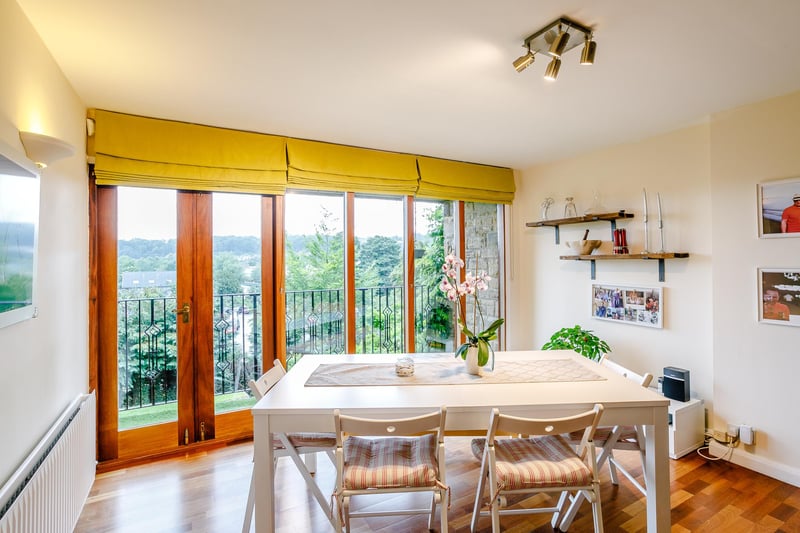 Stairs to the first floor open up directly in the dining room, boasting superb far-reaching views via the floor-to-ceiling glazing which in turn holds French doors out to a balcony.