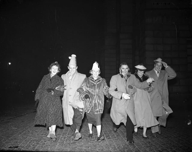 Six American visitors dance down the High Street during Hogmanay celebrations in 1955.