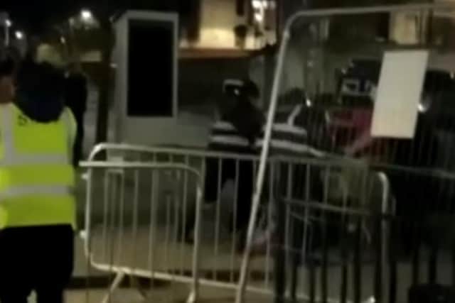 A still from a video which appears to show a security guard kicking a man on the ground outside Tank nightclub on Arundel Gate in Sheffield city centre