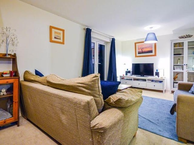 The large living room from a different angle. Imagine relaxing in style, feet up in front of the telly, after a hard day at work.