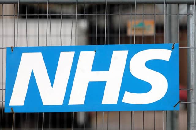 An NHS sign on a fence outside a hospital in England. PIC: PA