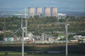 Wind turbines stand in front of the Fiddlers Ferry decommissioned coal fired power station. Getty Images.