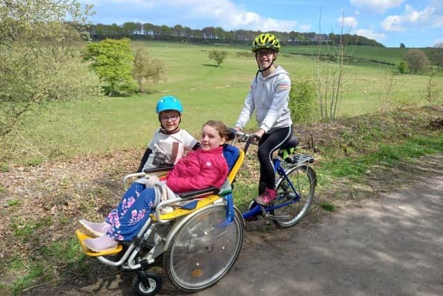 Molly, and her sister Anya, 11 and brother, Edmund, seven,  will complete 84 laps of a 220 metre indoor athletics track on her duet tandem wheelchair bicycle with their mum, May.