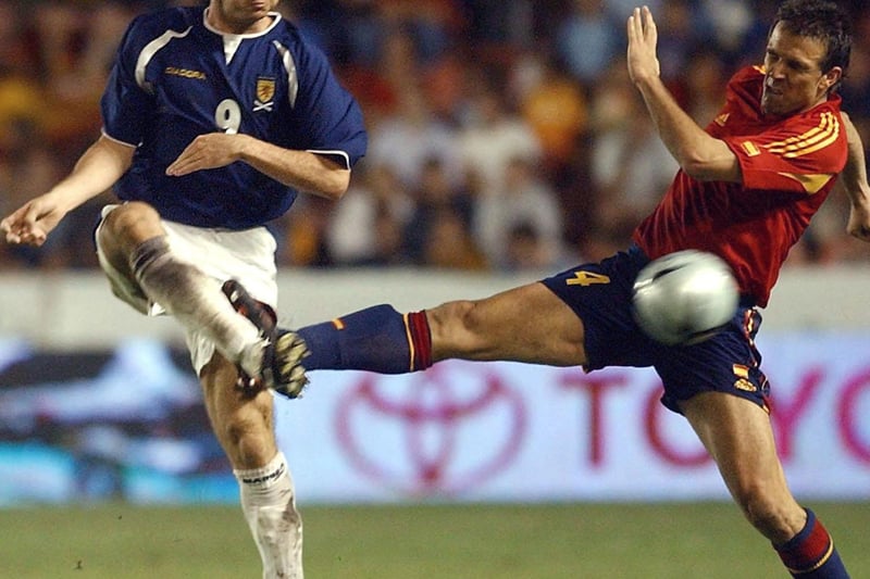 Scotland's Crawford, left, fights for the ball with Spain's Carlos Marchena in this friendly in Valencia, which ended one all.