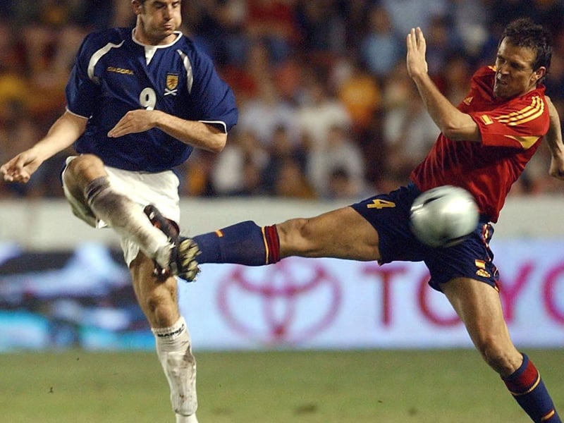 Scotland's Crawford, left, fights for the ball with Spain's Carlos Marchena in this friendly in Valencia, which ended one all.