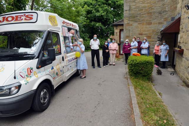 Beechy Knoll Residential Home in Sheffield. John McNeil from Joe's Ices ice cream van serves to Adele Waller.