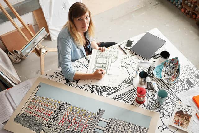 Jo Peel at work in her studio in Sheffield in 2015, when she had an exhibition in the Millennium Gallery, with a picture of Park Hill in the foreground