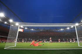 Pierre-Emerick Aubameyang scores from the penalty spot during the English Premier League football match between Arsenal and Leeds United. (Photo by CATHERINE IVILL/POOL/AFP via Getty Images)