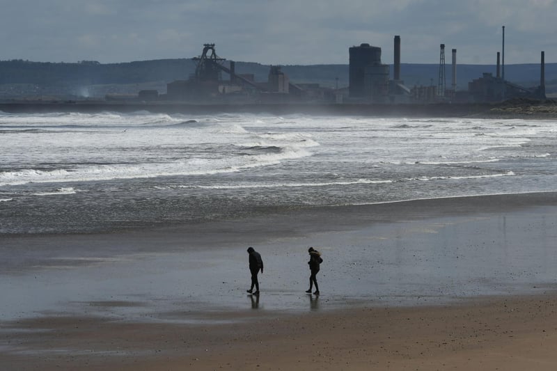 Walkers out on Seaton Carew beach.