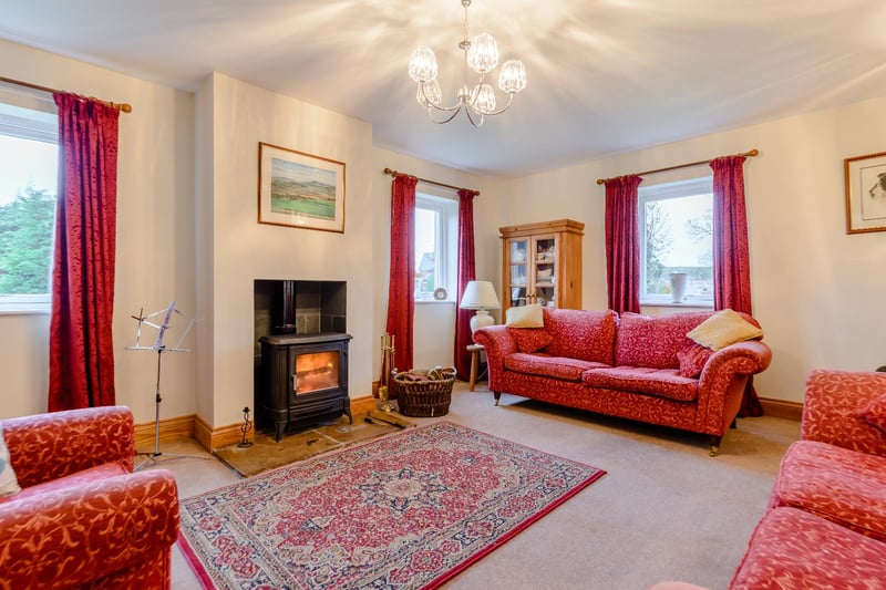 A well-proportioned drawing room that enjoys a dual aspect and features a woodburning stove.