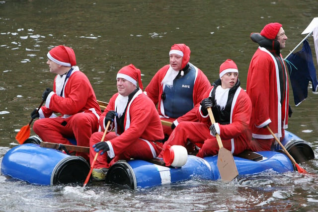 A raft of floating Father Chrstmases makes a seasonal visit to the annual Boxing Day Raft Race in Matlock in 2007