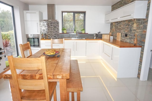 This light and airy kitchen features views of the back garden