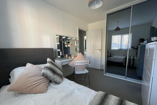 Another shot of the second bedroom shows those fitted wardrobes with tinted glass sliding doors.