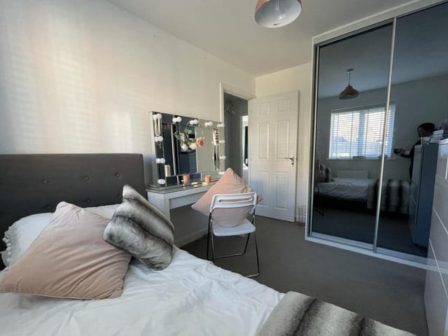 Another shot of the second bedroom shows those fitted wardrobes with tinted glass sliding doors.