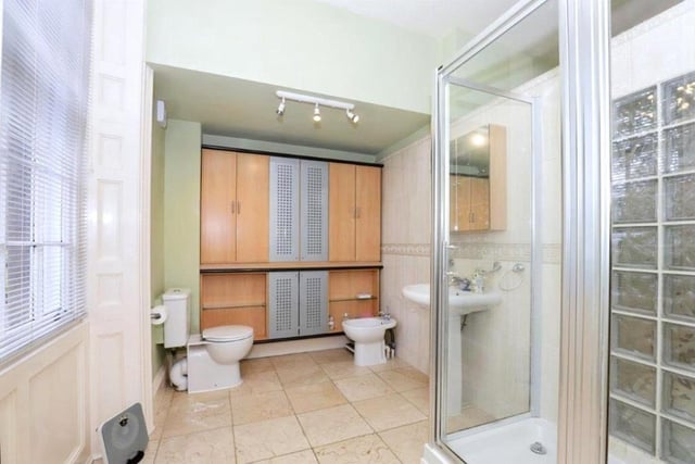 With a walk-in shower and white suite, this bathroom is light and spacious.