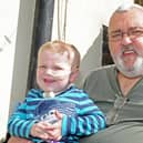 Kevan Adams, pictured with his grandson Jordan Reid at the age of two