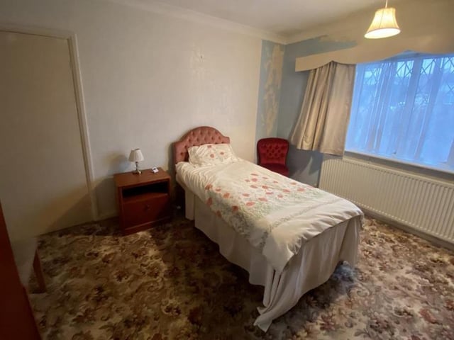 The master bedroom is spacious and features built-in wardrobes. There is a radiator and a uPVC window to the front of the bungalow.