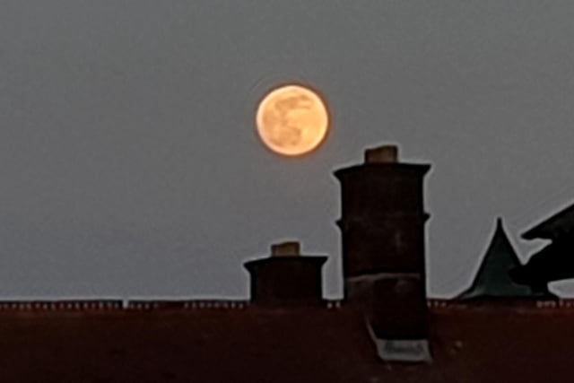 The April 7 supermoon looms over the chimneys of Fratton.