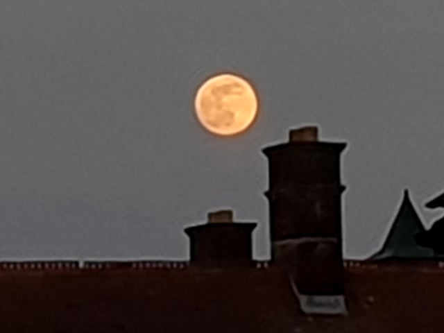 The April 7 supermoon looms over the chimneys of Fratton.