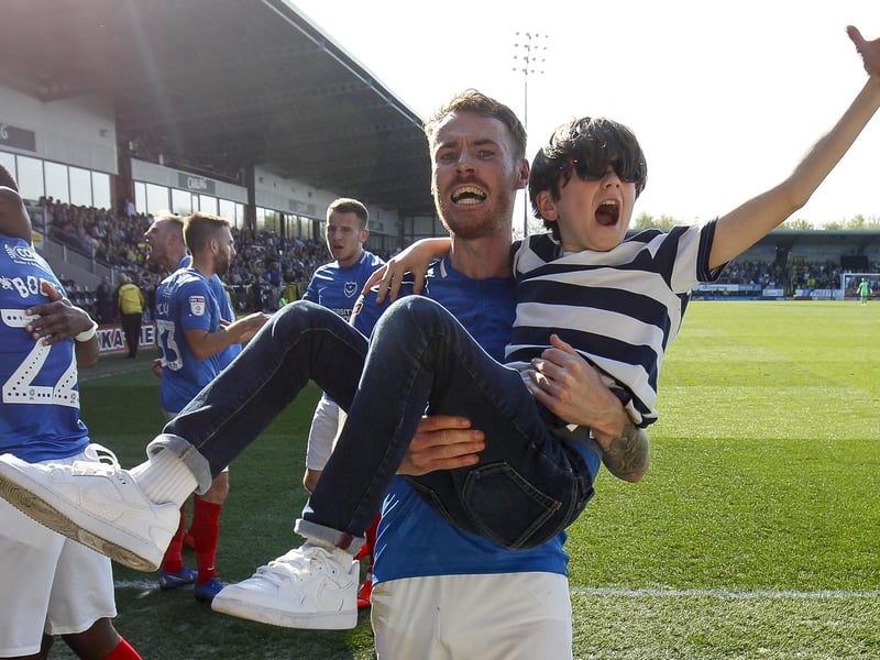 Tom Naylor carries a young fan after Pompey net their winner at Burton in April 2019.