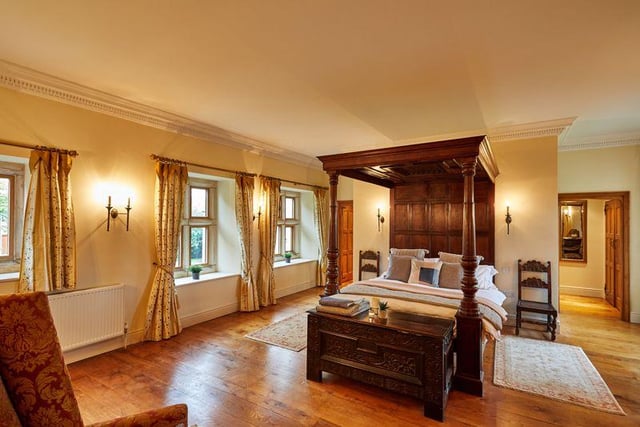 This generously sized master suite features an impressive four poster bed, wooden floors, a large en-suite bathroom and a dressing area, with plenty of light coming in from the many windows.