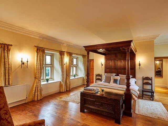 This generously sized master suite features an impressive four poster bed, wooden floors, a large en-suite bathroom and a dressing area, with plenty of light coming in from the many windows.
