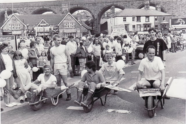 Buxton Advertiser archive, start of the wheelbarrow race before the carnival  1987.Took place instead of the 5 mile road race due to the construction of the the Spring Gardens Relief road.